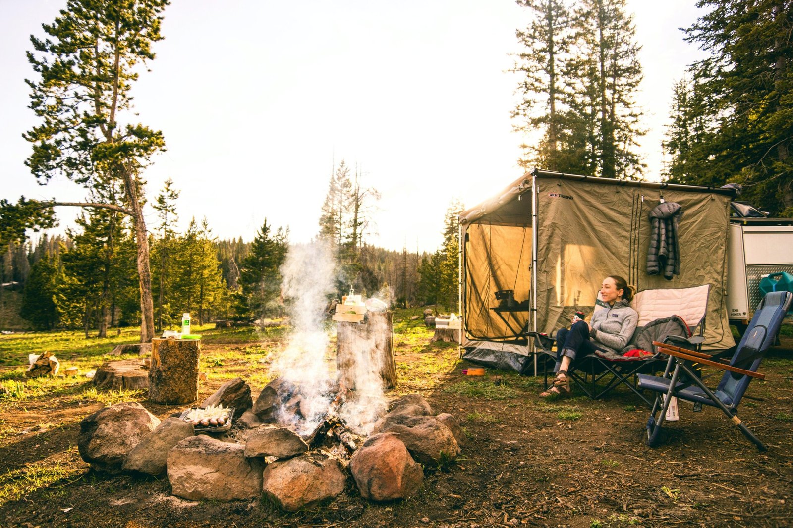 woman sitting on chair near tent